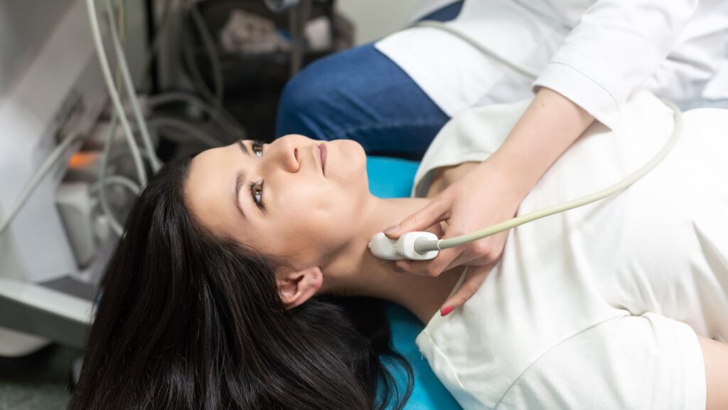A patient undergoing thyroid ultrasound services with a skilled technician in a clinic, reflecting the comprehensive diagnostic services offered at Main Ultrasound in Hamilton.