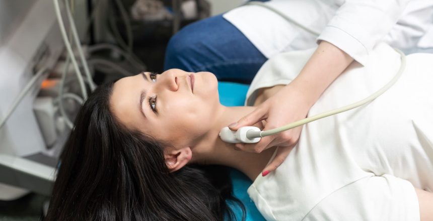 A patient undergoing thyroid ultrasound services with a skilled technician in a clinic, reflecting the comprehensive diagnostic services offered at Main Ultrasound in Hamilton.